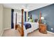 Bedroom with four-poster bed, dark blue accent wall, and decorative side tables at 7480 Katelyn Ct, Harrisburg, NC 28075