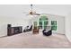 Spacious bonus room with ample natural light and varied seating options at 7480 Katelyn Ct, Harrisburg, NC 28075