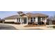 Exterior of clubhouse featuring a stone foundation and well-manicured landscaping at 7480 Katelyn Ct, Harrisburg, NC 28075