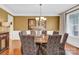 Formal dining room with stylish chairs, a round table, and elegant chandelier at 7480 Katelyn Ct, Harrisburg, NC 28075