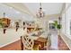 Open concept dining area adjacent to the kitchen, featuring a chandelier and access to the deck at 7480 Katelyn Ct, Harrisburg, NC 28075