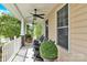 Relaxing covered front porch featuring rocking chairs, ceiling fans, and ample space at 7480 Katelyn Ct, Harrisburg, NC 28075