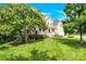 Well-manicured front yard with lush green grass and mature trees surrounding the home at 7480 Katelyn Ct, Harrisburg, NC 28075