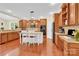Open kitchen showcases granite countertops, stainless steel appliances, wooden cabinets, and hardwood floors at 7480 Katelyn Ct, Harrisburg, NC 28075