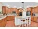 Well-equipped kitchen featuring wooden cabinets, granite countertops, a kitchen island, and stainless steel appliances at 7480 Katelyn Ct, Harrisburg, NC 28075
