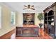 Sophisticated office with dark wood accents, built-in shelving, and hardwood flooring at 7480 Katelyn Ct, Harrisburg, NC 28075