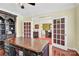 Elegant office featuring a large desk, hardwood floors, and decorative french doors at 7480 Katelyn Ct, Harrisburg, NC 28075