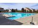 A large, pristine neighborhood swimming pool surrounded by homes and greenery at 7480 Katelyn Ct, Harrisburg, NC 28075