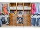Organized walk-in closet with built-in shelves and clothing racks at 7480 Katelyn Ct, Harrisburg, NC 28075