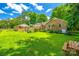 Expansive backyard with a well-manicured lawn and mature trees, ideal for outdoor recreation and entertaining at 7712 Old Waxhaw Monroe Rd, Waxhaw, NC 28173