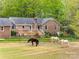 Expansive backyard with a deck, paddock and horses enjoying the green scenery at 7712 Old Waxhaw Monroe Rd, Waxhaw, NC 28173