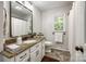 Clean bathroom with granite countertop, stylish mirror and updated fixtures at 7712 Old Waxhaw Monroe Rd, Waxhaw, NC 28173