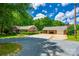Beautiful brick home and detached garage with ample parking and an American flag at 7712 Old Waxhaw Monroe Rd, Waxhaw, NC 28173