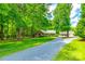Charming brick home with long driveway, lush lawn, and detached two-car garage at 7712 Old Waxhaw Monroe Rd, Waxhaw, NC 28173