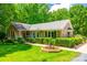 Beautiful brick home with well-manicured landscaping, a charming porch, and classic architectural details at 7712 Old Waxhaw Monroe Rd, Waxhaw, NC 28173