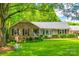 Charming home boasts a brick facade, manicured lawn, and cozy front porch at 7712 Old Waxhaw Monroe Rd, Waxhaw, NC 28173