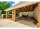 Covered parking area with brick pillars and an open ceiling, providing shelter for vehicles and additional storage space at 7712 Old Waxhaw Monroe Rd, Waxhaw, NC 28173