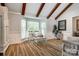 Bright living room with wood beams, large windows, and stylish decor at 7712 Old Waxhaw Monroe Rd, Waxhaw, NC 28173