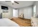 Spacious bedroom with wood floors, a ceiling fan, and large closets, providing ample storage space and comfort at 7712 Old Waxhaw Monroe Rd, Waxhaw, NC 28173