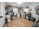 Inviting office space with built-in bookshelves, wood floors, and an easel, perfect for working from home or creative pursuits at 7712 Old Waxhaw Monroe Rd, Waxhaw, NC 28173