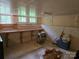 A basement with a few windows, a bare concrete floor, and a wooden shelf at 804 Dennis St, Troy, NC 27371