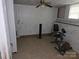 A sparsely decorated basement featuring exercise equipment and tile flooring at 804 Dennis St, Troy, NC 27371