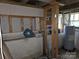 An unfinished basement with visible framing, exposed utilities, and a hot water heater at 804 Dennis St, Troy, NC 27371