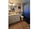 A well-lit bathroom featuring a vanity, toilet, and a shower with a decorative curtain at 804 Dennis St, Troy, NC 27371