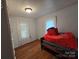 An inviting bedroom with hardwood floors, natural light, and comfortable furnishings at 804 Dennis St, Troy, NC 27371