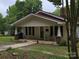 Charming single-story home with a welcoming front porch and well-maintained lawn at 804 Dennis St, Troy, NC 27371