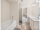 Bright bathroom with a tub, tile floors, and walk in shower at 8314 Paw Valley Ln, Charlotte, NC 28214