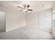 Neutral bedroom boasts a ceiling fan and white trim, showcasing simplicity and comfort at 8314 Paw Valley Ln, Charlotte, NC 28214