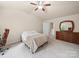 Bedroom with neutral carpet, ceiling fan, dresser and closet at 8314 Paw Valley Ln, Charlotte, NC 28214