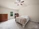 Bedroom with carpet, dresser, ceiling fan, and natural light from the windows at 8314 Paw Valley Ln, Charlotte, NC 28214