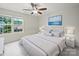 Bright bedroom with large window, ceiling fan, and serene wall art at 8314 Paw Valley Ln, Charlotte, NC 28214