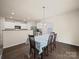Bright dining room with wood floors and ample natural light near the kitchen at 8314 Paw Valley Ln, Charlotte, NC 28214