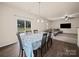 Open-concept dining room flowing to the living room with sliding glass door access at 8314 Paw Valley Ln, Charlotte, NC 28214