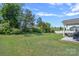 Large, well-maintained backyard with lush green grass, mature trees, and a partially covered patio at 9110 Buckley Ct # 154, Charlotte, NC 28269