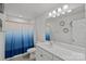 Bright bathroom featuring a vanity with ample counter space, decorative mirror, and a shower with curtain at 9110 Buckley Ct # 154, Charlotte, NC 28269