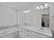 Elegant bathroom with double vanity, soaking tub, and large mirror at 9110 Buckley Ct # 154, Charlotte, NC 28269