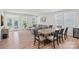 Bright dining area with wood floors, table with seating, and access to the backyard at 9110 Buckley Ct # 154, Charlotte, NC 28269