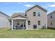 Rear exterior view of a well-maintained home featuring a covered patio and green lawn at 9110 Buckley Ct # 154, Charlotte, NC 28269