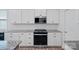Kitchen with white cabinets, stainless steel oven, and granite countertops at 9110 Buckley Ct # 154, Charlotte, NC 28269