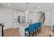 Kitchen with white cabinets, granite countertops, island seating, and stainless steel appliances at 9110 Buckley Ct # 154, Charlotte, NC 28269