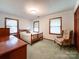 This bedroom has natural light, classic wood trim, and a neutral palette creating a serene space at 965 Hunting Ave, Lincolnton, NC 28092