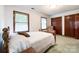 Bright bedroom featuring a cozy chair, neutral walls, and classic wood trim around the windows and doors at 965 Hunting Ave, Lincolnton, NC 28092