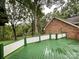 Large, open deck with a railing, offering views of the surrounding trees at 965 Hunting Ave, Lincolnton, NC 28092