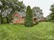 Brick home with a well-kept lawn and mature trees in a serene setting at 965 Hunting Ave, Lincolnton, NC 28092