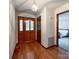 Inviting foyer with hardwood floors, wood door with glass, and access to a bedroom at 965 Hunting Ave, Lincolnton, NC 28092