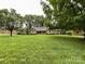 Spacious front yard with a charming brick home and mature trees at 965 Hunting Ave, Lincolnton, NC 28092